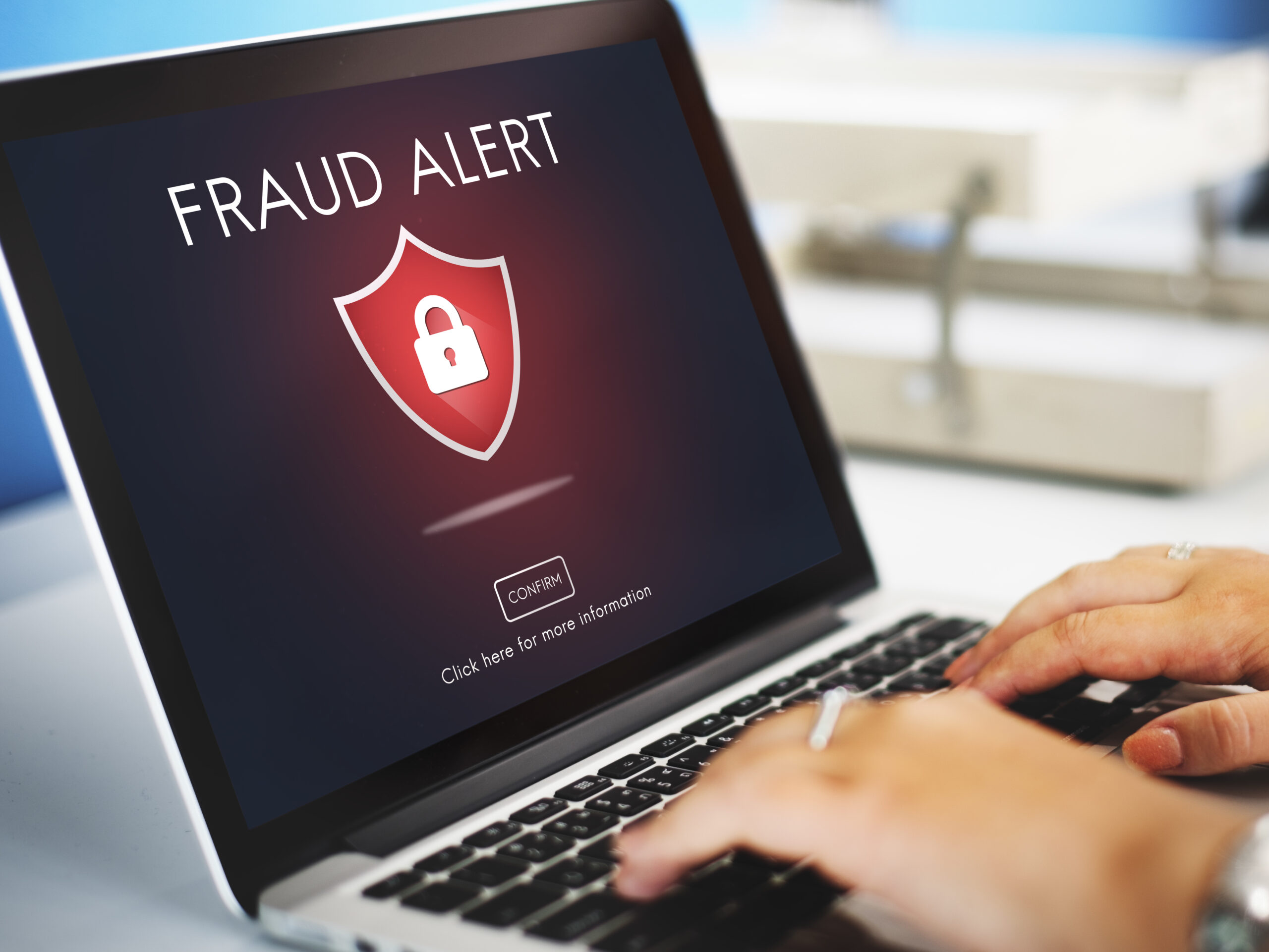 Fraud alert message on a laptop screen indicating cybersecurity threat awareness for businesses