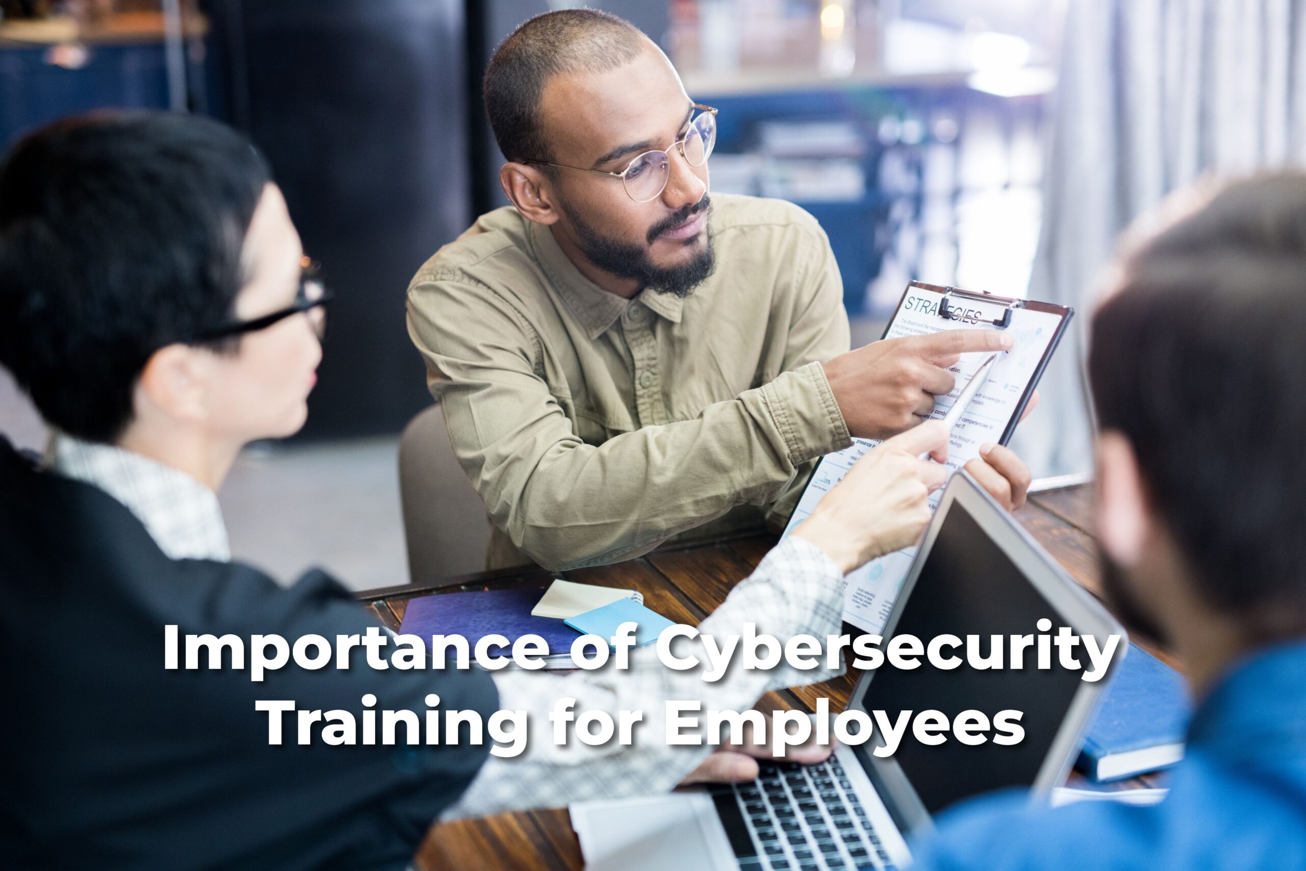 Employees engaged in a discussion on cybersecurity strategies, emphasizing the importance of training staff to recognize and prevent cyber threats